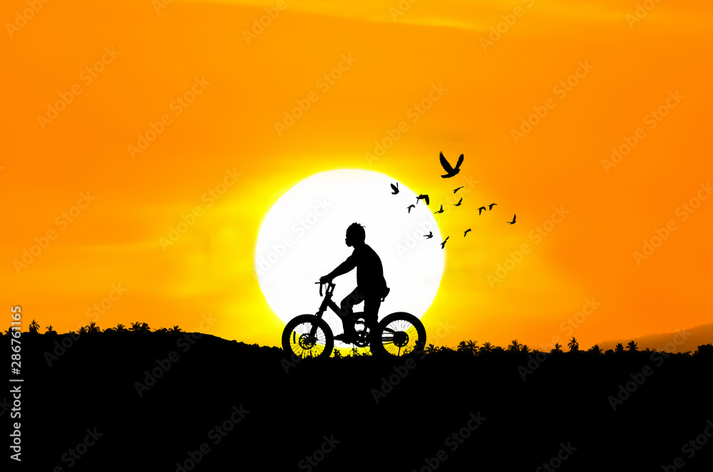Silhouette illustration of a boy riding a bicycle Silhouette illustration of a boy riding a bicycle