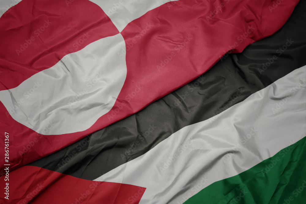 waving colorful flag of palestine and national flag of greenland. waving colorful flag of palestine and national flag of greenland.