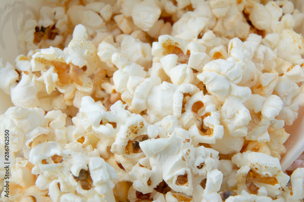 Solt or sweety popcorn close-up. Background of popcorn. Snacks and food for a movie