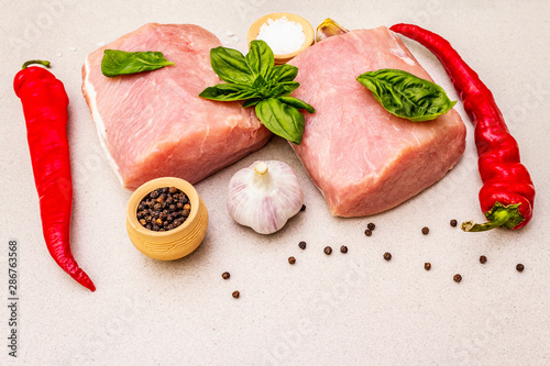 Raw pork meat loin with fresh vegetables and dry spice