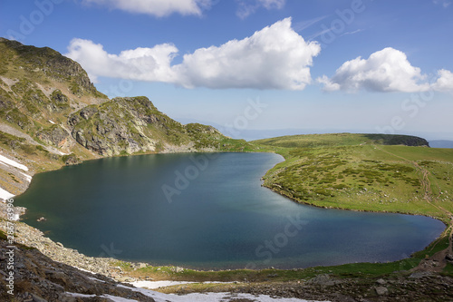 Beautifully lit the Kidney lake  one of the most beautiful of the seven Rila lakes in Bulgaria  impressive mountains and sunlit highlands