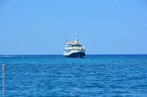 pleasure ship at sea against a clear summer sky © neprolet