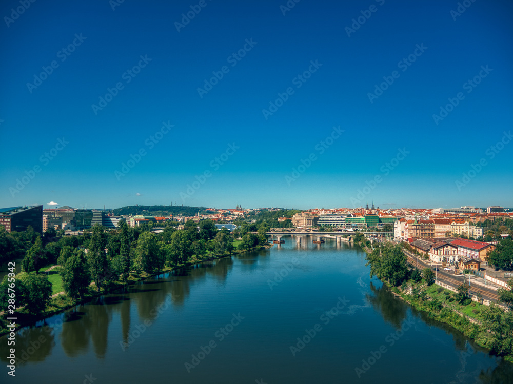 aerial flight over vltava river next to bridges sunny day of summer in Prague