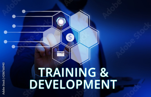 Word writing text Training And Development. Business photo showcasing learn specific knowledge to improve perforanalysisce Male human wear formal work suit presenting presentation using smart device