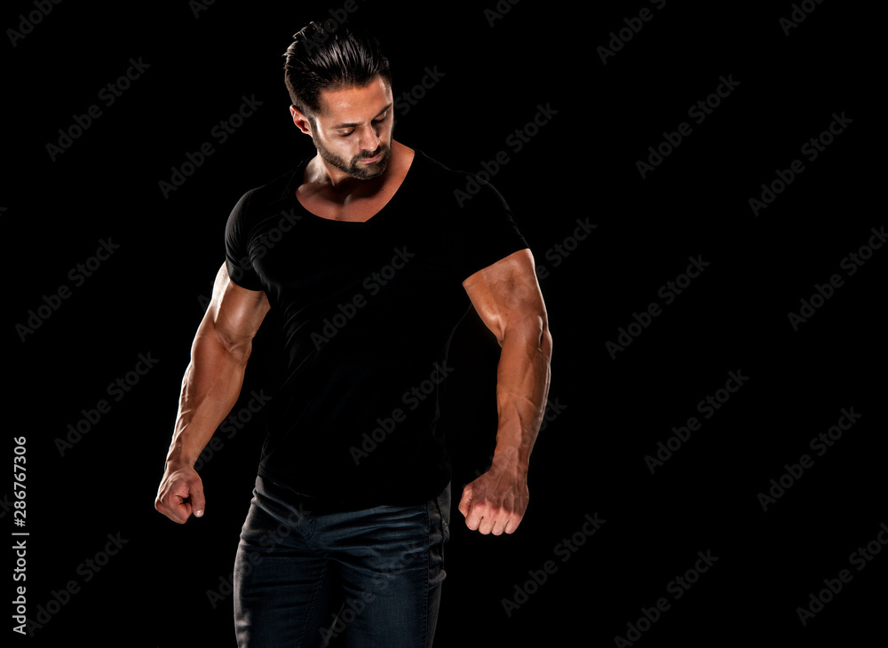 Naklejka premium Handsome Male Fitness Model Wearing Jeans and Black T-Shirts