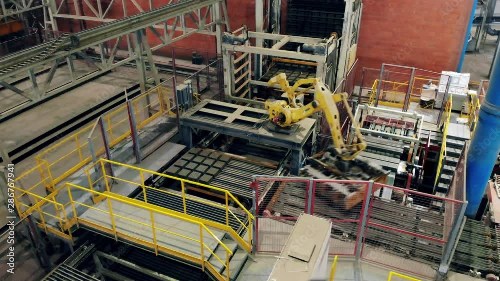 Factory industrial equipment works with bricks on a conveyor. Factory industrial equipment works with bricks on a conveyor.