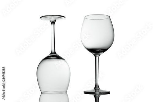 Clean Empty wine glasses with reflections on white background. Alcohol beverage card backdrop.