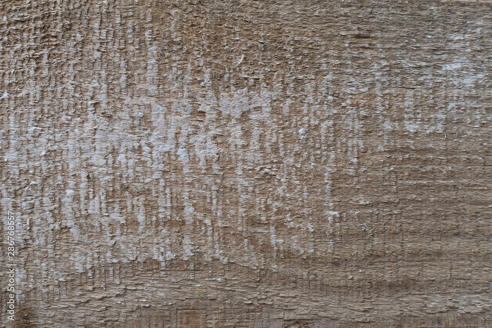 Old gray-brown natural wood background in the form of a board with cracks, knots and a rough surface Old gray-brown natural wood background in the form of a board with cracks, knots and a rough surface