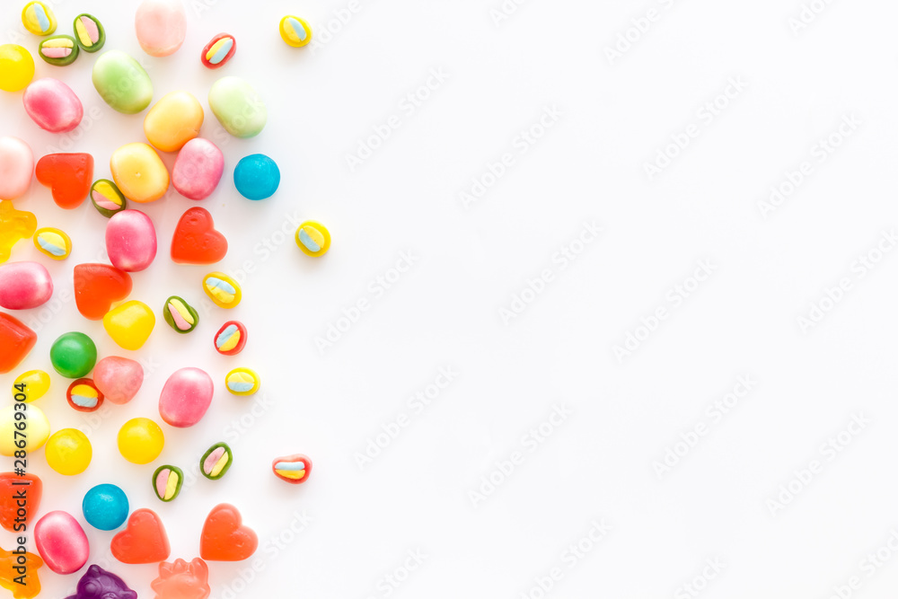 Assorted sweets and marmalade on white background top view space for text