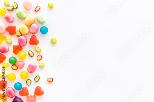Assorted sweets and marmalade on white background top view space for text