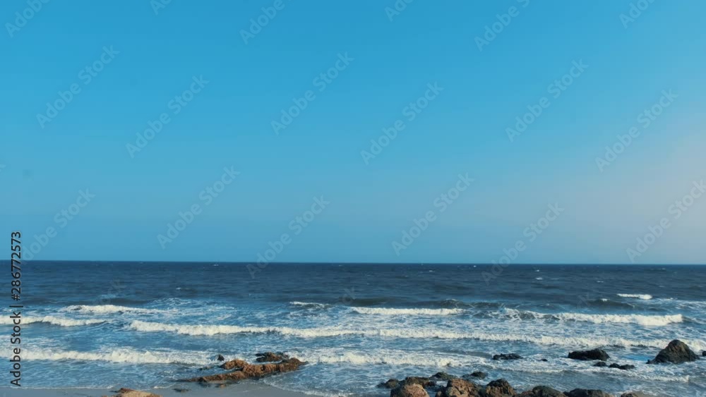 Beautiful waves in the sea, amazing nature beach background. Royalty high-quality stock video footage ocean water, sea surface, sand. Turquoise waves, clear water surface background for tex and design