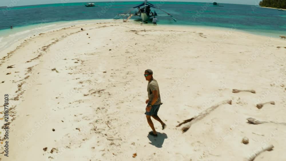 Cheerful man runs along the tropical beach and gets fun and joy on vacation. Cheerful man runs along the tropical beach and gets fun and joy on vacation.