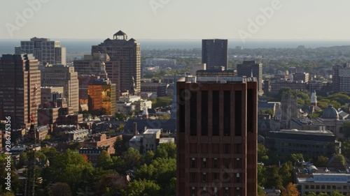 New Haven Connecticut Aerial v7 Panning away from close up of Yale university tower to wide campus view with building in foreground - October 2017 photo