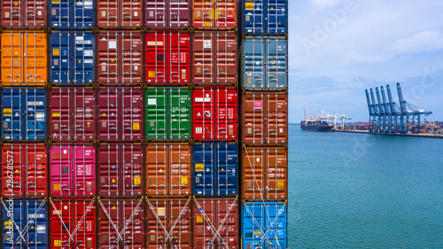 Container ship loading and unloading in deep sea port, Aerial top view of business logistic import and export freight transportation by container ship in open sea.