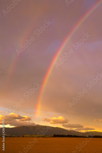 An evening rainbow lights up the evening sky in Canterbury, New Zealand