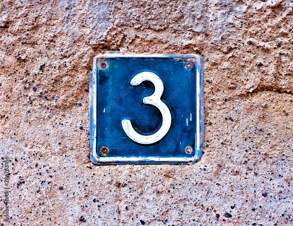 3, number three, blue plate with number on a wall surface. 3, number three, blue plate with number on a wall surface.