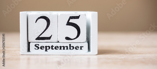 25 September of calendar wooden on table, World pharmacist day concept