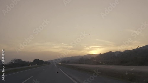 driving on highway at sunset