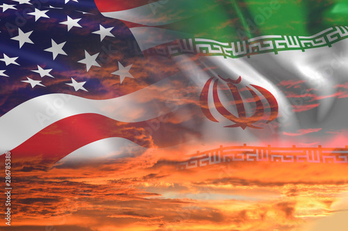 USA United States of America and Iran relations - iran us war with flags on stormy cloudy orange sky background photo