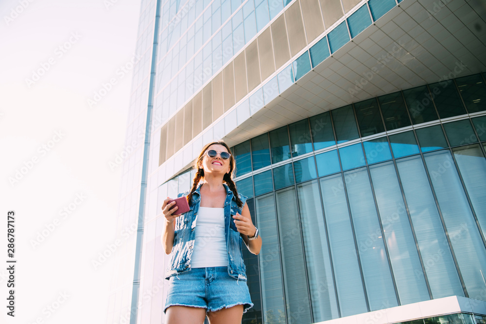 Portrait of a beautiful woman with pigtails smiling taking a selfie