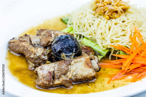 Baked pork ribs with noodle on white plate, Thai style food on white background