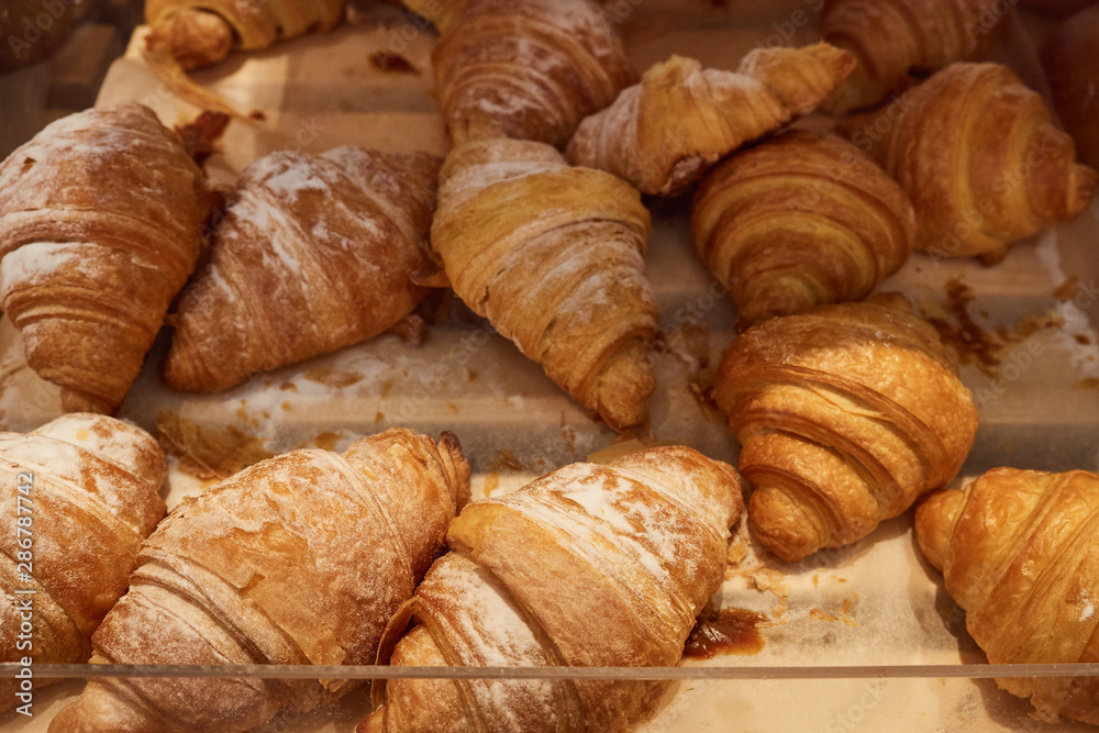 many croissants on a supermarket shelf for sale many croissants on a supermarket shelf for sale