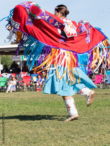 Young Native American Woman Dancing with Shawl Over Outstretched Arms
