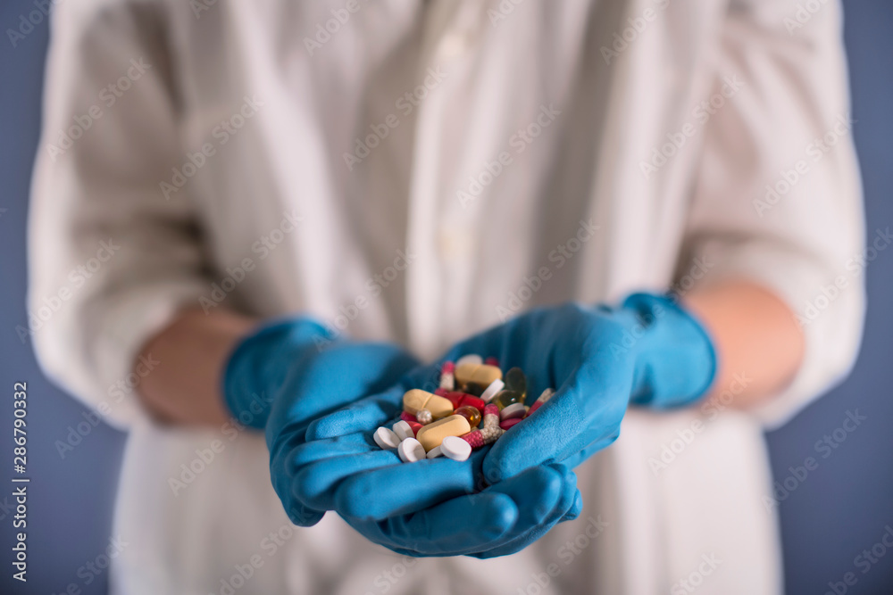 Handful of pills in doctor's hand Handful of pills in doctor's hand