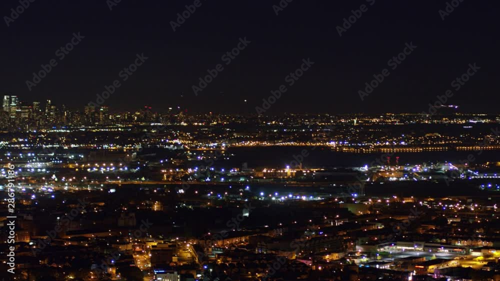Newark New Jersey Aerial v14 Nighttime panning cityscape with New York, Jersey City, & Newark views with airplane arrival - October 2017 Newark New Jersey Aerial v14 Nighttime panning cityscape with New York, Jersey City, & Newark views with airplane arrival - October 2017