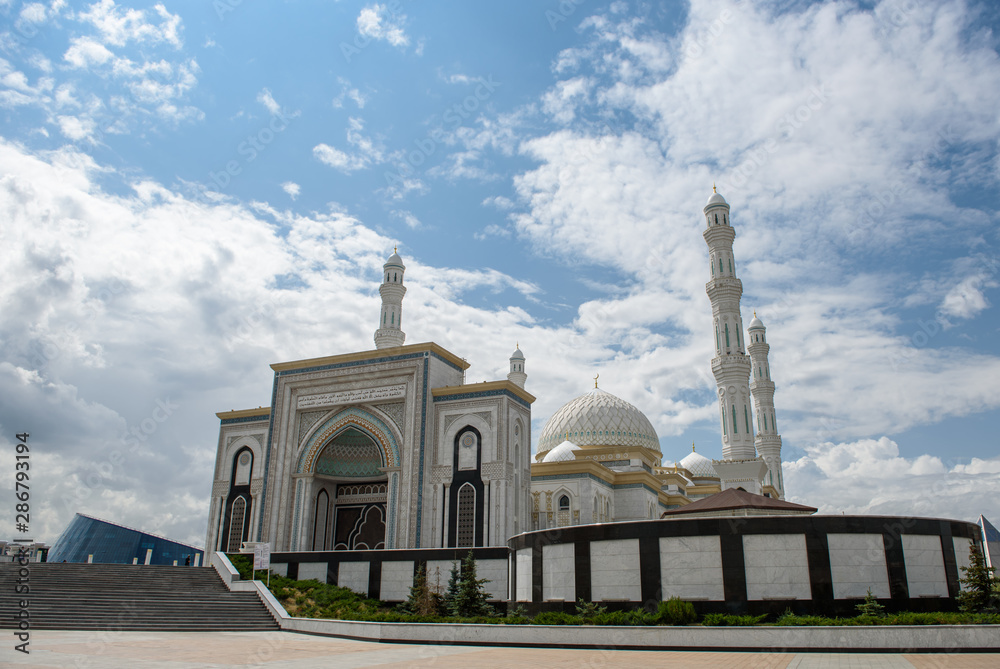 Hazret Sultan Mosque in the city of Nur Sultan. Beautiful white building of a mosque on a sunny day.
