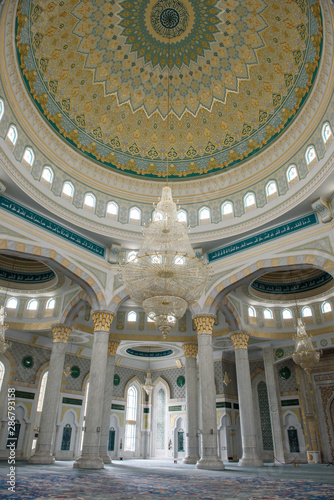 Hazret Sultan Mosque in the city of Nur Sultan. The interior of the mosque, dome and chandelier.