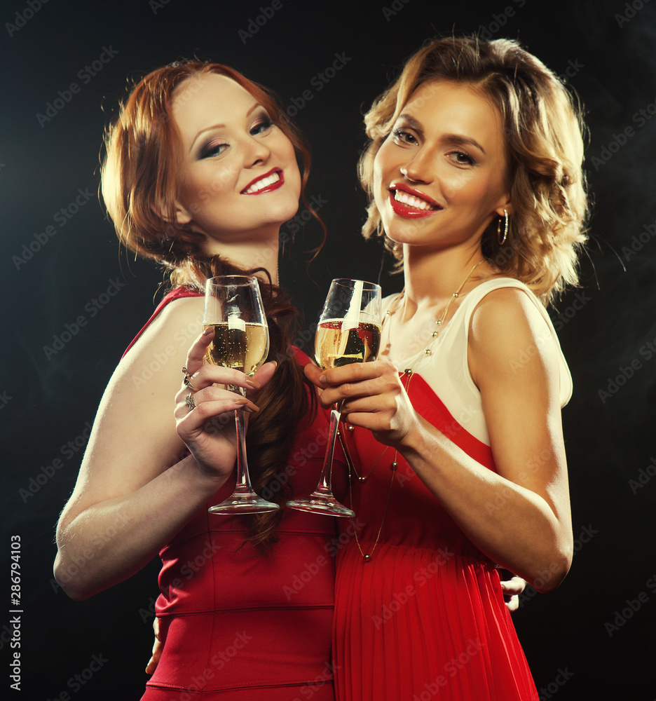 two beautiful young women with wine glasses