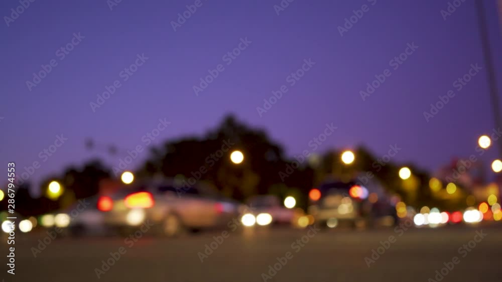 Ancient city square at night with cars passing, motorcycles by at rush hour Ancient city square at night with cars passing, motorcycles by at rush hour