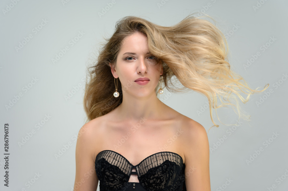 A large photo portrait of a pretty model with long flowing hair and a beautiful hairstyle on a white background. A large photo portrait of a pretty model with long flowing hair and a beautiful hairstyle on a white background.