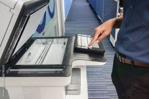 close up businessman set the printer function by touch screen