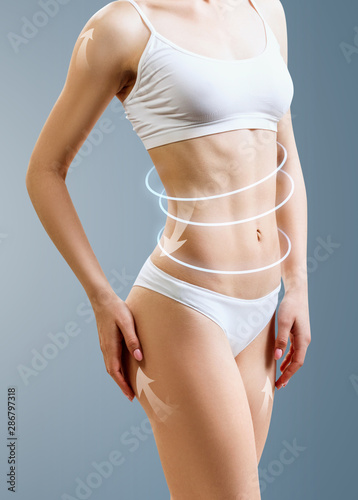 Slim woman body with glowing circles shows lifting effect.
