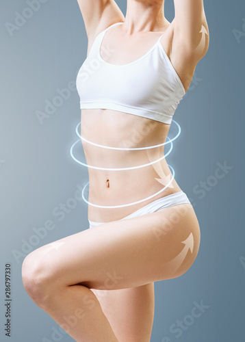 Slim woman body with glowing circles shows lifting effect.