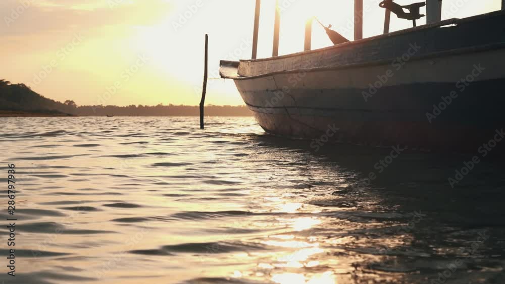 Sun Shining Through a Boat on the Lake at Sunset Sun Shining Through a Boat on the Lake at Sunset