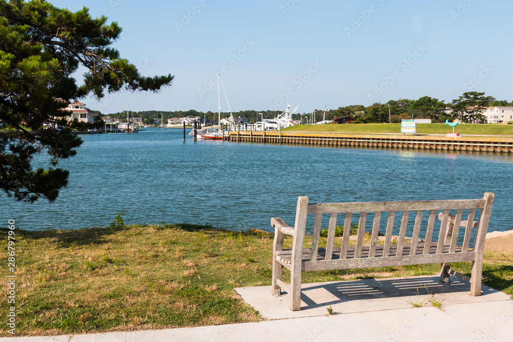 A bench sits facing Lake Wesley at Rudee Inlet in Virginia Beach, Virginia.