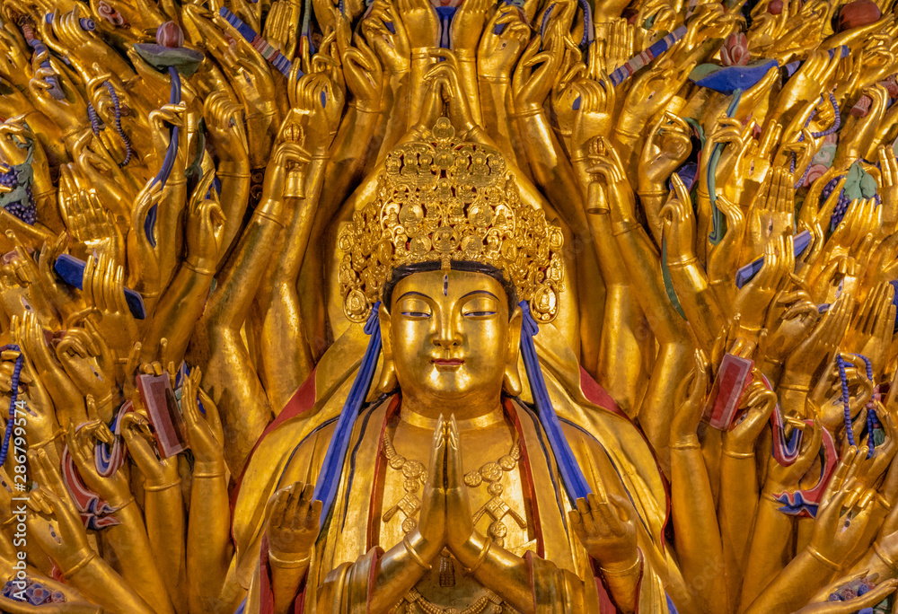 Fototapeta premium Golden sculpture of Avalokiteshvara Buddha or Guanyin with thousand hands at Dazu Rock Carvings at Mount Baoding or Baodingshan in Dazu, Chongqing, China. UNESCO World Heritage Site.