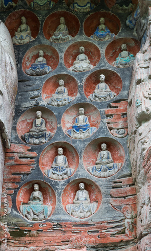 Buddha niches wall at Dazu Rock Carvings at Mount Baoding or Baodingshan in Dazu, Chongqing, China. UNESCO World Heritage Site.  photo