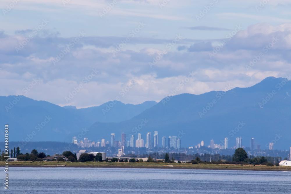 A view of a city and mountains across a bay