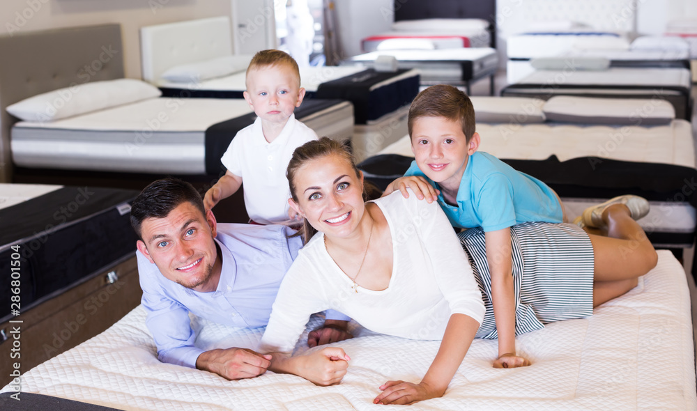 Family choosing mattress in store