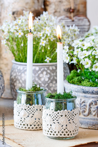 Simple glass jars transformed into a beautiful candle holders decorated with lace and moss.