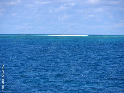 Stretch of sandbar in the middle of the ocean in the distance