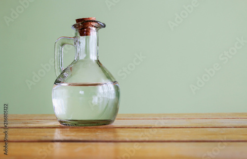 Classic glass bottle with transparent liquid. photo