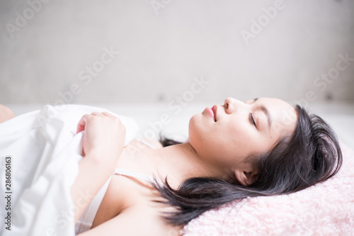 Young woman sleeping on bed