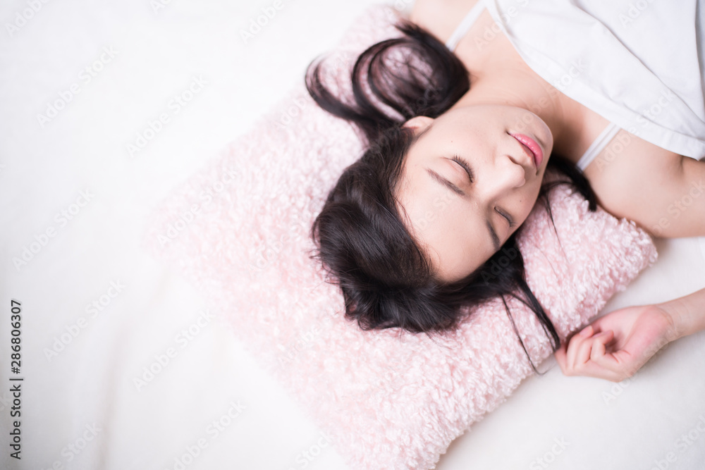 Young woman sleeping on bed Young woman sleeping on bed