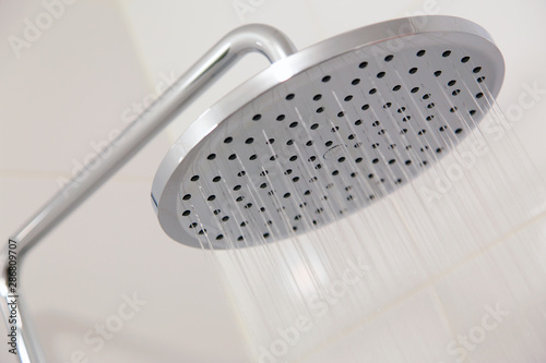  Chrome shower on white tile.Horizontally, Vertically.