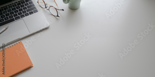 Trendy workplace with laptop and office supplies on white table background